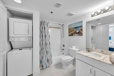 a white bathroom with a toilet and a sink at Spacious 1 Bed 1 BTH Brickell Ocean View in Miami