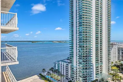 a view of the ocean from the balcony of a tall building at Spacious 1 Bed 1 BTH Brickell Ocean View in Miami