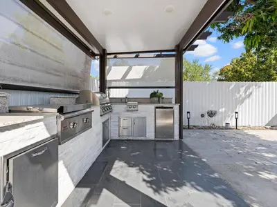 an outdoor kitchen with stainless steel appliances at The Chill Sunny Casa Near Beaches in Miami Lakes