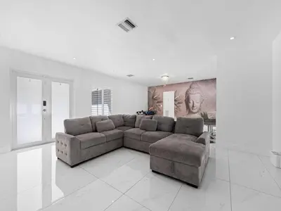 a large living room with a couch and a table at The Chill Sunny Casa Near Beaches in Miami Lakes