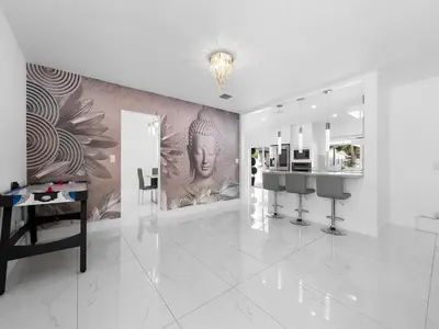 a white room with a wall with a painting on it at The Chill Sunny Casa Near Beaches in Miami Lakes