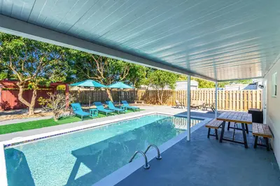 a swimming pool with a pergola next to a house at Relax & Fun Hollywood Private Pool | Arcade Game in Hollywood