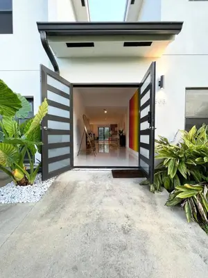 an open door into a house with plants at Lux Retreat with Pool Near Beach in Fort Lauderdale