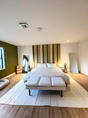a bedroom with a large bed and a striped wall at Lux Retreat with Pool Near Beach in Fort Lauderdale