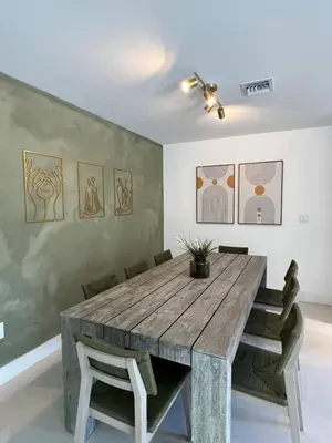a dining room with a wooden table and chairs at Lux Retreat with Pool Near Beach in Fort Lauderdale