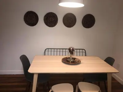 a dining room table with chairs and plates on the wall at 2 Bedroom Apartment Free Reserved Parking in Miami