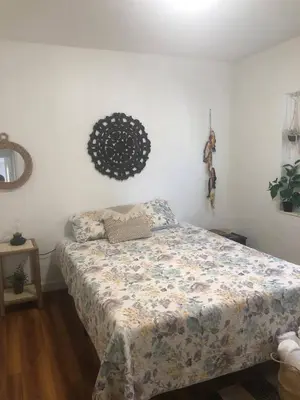 a bedroom with a bed with a comforter on it at 2 Bedroom Apartment Free Reserved Parking in Miami