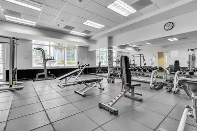 a gym with a lot of treadmills and machines at Elegant 1 BR Retreat in Brickell With Free Parking in Miami