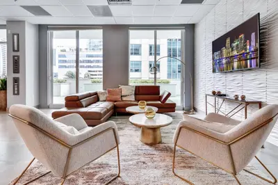 a living room with a couch and chairs and a table at Elegant 1 BR Retreat in Brickell With Free Parking in Miami