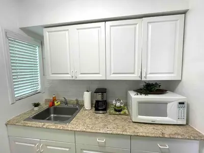 a kitchen counter with a sink and a microwave at Apartment in the Heart of Calle 8 with Parking in Miami