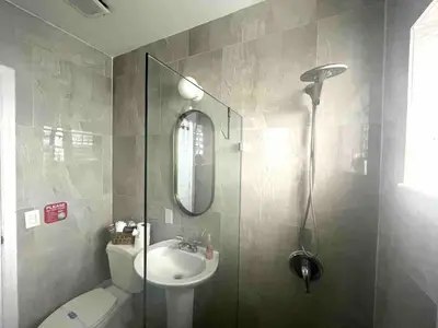 a bathroom with a shower and a toilet and a sink at Apartment in the Heart of Calle 8 with Parking in Miami