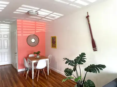 a dining room with a table and a plant at Apartment in the Heart of Calle 8 with Parking in Miami