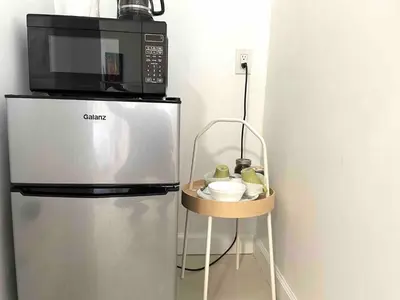 a microwave sitting on top of a refrigerator at Walk to Calle 8 - Authentic Cuban Experience in Miami