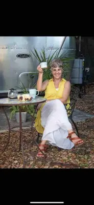 a woman sitting in a chair at a table at Unique Studio in Little Havana Reserved Parking in Miami