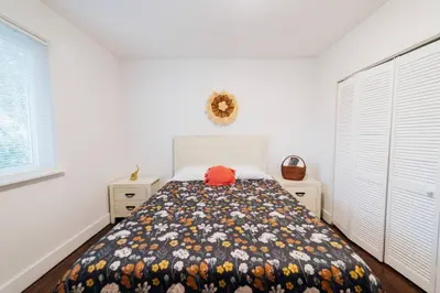 a bedroom with a bed and two dressers at 3 Bedroom Apartment with Backyard Oasis in Miami
