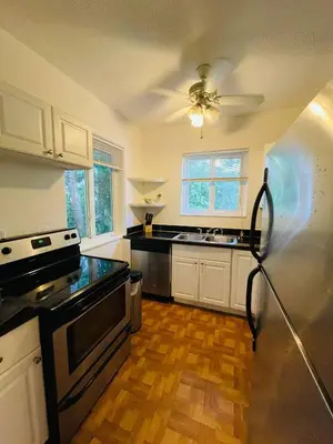 a kitchen with black counter tops and a refrigerator at Families Welcome 3 Bedroom Oasis with Parking in Miami