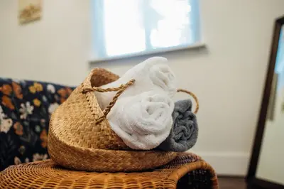 a pile of towels sitting on top of a basket at Families Welcome 3 Bedroom Oasis with Parking in Miami