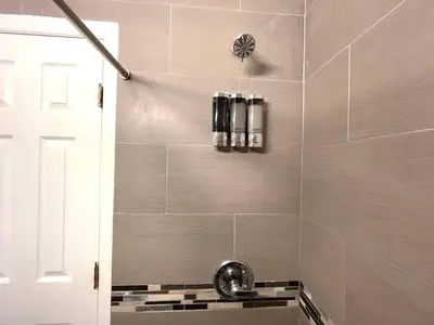 a bathroom with a shower with a sink at Tropical Paradise in Miracle Mile with Parking in Miami