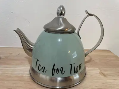 a tea kettle with a tea for just written on it at Tropical Paradise in Miracle Mile with Parking in Miami