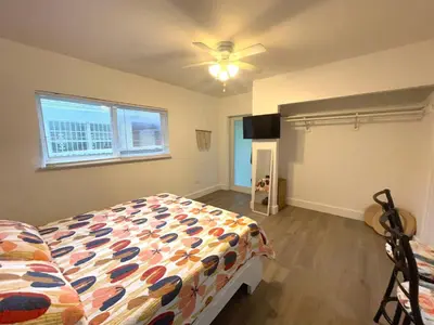 a bedroom with a bed and a ceiling fan at Tropical Paradise in Miracle Mile with Parking in Miami