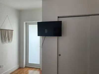 a room with a door with a television on the wall at Tropical Paradise in Miracle Mile with Parking in Miami