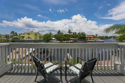 two chairs on a deck with a view of the water at Waterside retreat in Fort Lauderdale