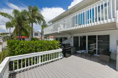 a balcony of a house with a wooden deck at Waterside retreat in Fort Lauderdale