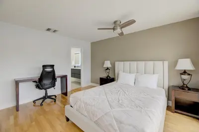 a bedroom with a bed and a desk and a chair at Waterside retreat in Fort Lauderdale