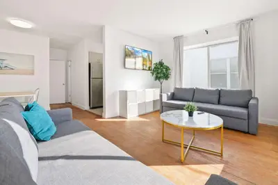 a living room with a couch and a table at Modern Miami Beach Apt King & Sofa Bed Comfort in Miami Beach