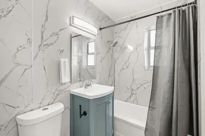 a bathroom with a sink and a toilet and a tub at Miami Magic 1BR 4 Guests in Miami Beach