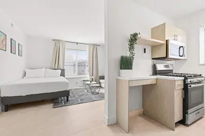 a room with a kitchen with a bed and a stove at Miami Magic 1BR 4 Guests in Miami Beach