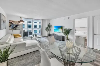 a living room with a white couch and a glass table at Brickell 1 Bed 1 Bath Free Parking in Miami