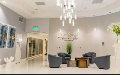 a waiting room with chairs and a sign on the wall at Brickell 1 Bed 1 Bath Free Parking in Miami