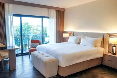 a hotel room with a large bed and a balcony at Barley House Hotel, Trademark Collection by Wyndham in Fort Lauderdale