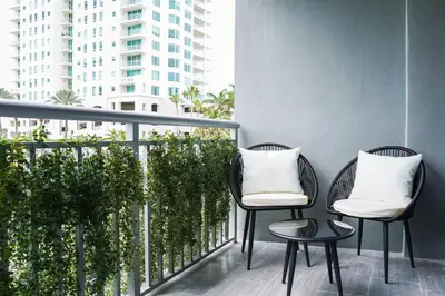 two chairs and a table on a balcony at Barley House Hotel, Trademark Collection by Wyndham in Fort Lauderdale