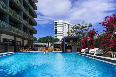 a large swimming pool in front of a building at Barley House Hotel, Trademark Collection by Wyndham in Fort Lauderdale