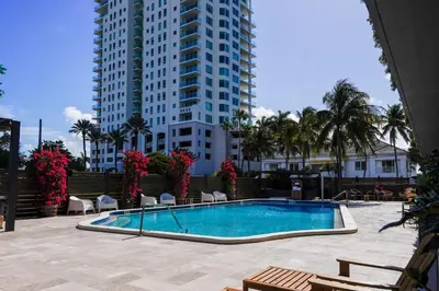 a swimming pool in front of a tall building at Barley House Hotel, Trademark Collection by Wyndham in Fort Lauderdale