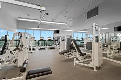 a gym with treadmills and machines in a building at Private Residences at Hotel Arya by SoFLA Vacations in Miami