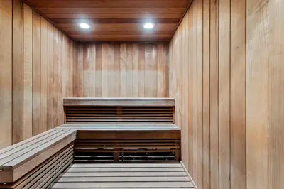 a sauna with a wooden wall and two lights at Private Residences at Hotel Arya by SoFLA Vacations in Miami