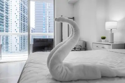 a swan made out of towels on a bed at Brickell Nights, Icon Lights 1BR Luxe Stay in Miami