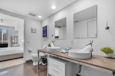 a white bathroom with two sinks and a bed at Brickell Nights, Icon Lights 1BR Luxe Stay in Miami