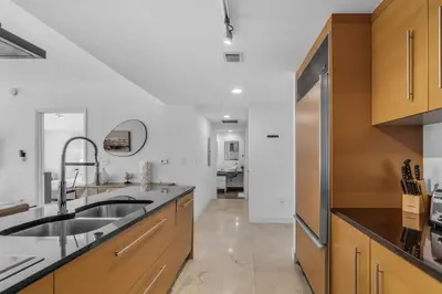 a kitchen with a sink and a refrigerator at Brickell Nights, Icon Lights 1BR Luxe Stay in Miami