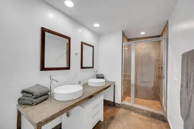 a bathroom with two sinks and a shower at Sun, Style and Skyline Modern Icon Brickell 2BR in Miami