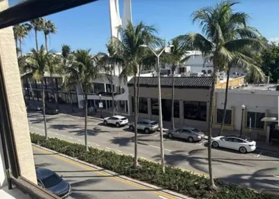 a view of a parking lot with palm trees at Walk to South Beach in Miami Beach