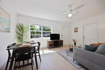 a living room with a table and a couch at 10 min to Las Olas and Beach WD 2 Bed in Fort Lauderdale