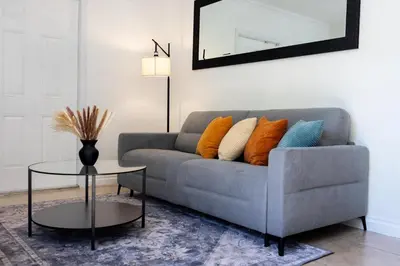 a living room with a couch and a table at 10 min to Las Olas and Beach WD 2 Bed in Fort Lauderdale