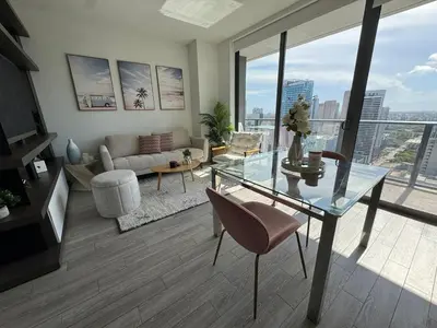 a living room with a glass table and a couch at Luxury Downtown Miami Stay in Upscale Building in Miami