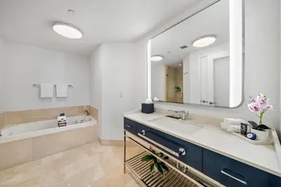 a bathroom with a sink and a large mirror at Ocean View Private Residence at Fontainebleau -3505 in Miami Beach