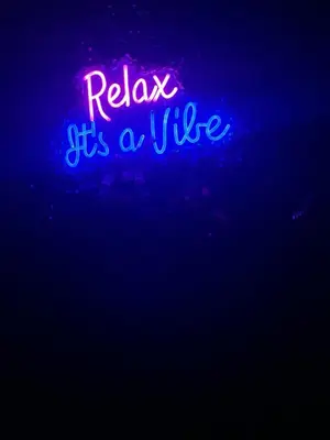 a neon sign that says relax its a cure at Tropical Oasis in Pembroke Pines