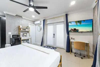 a bedroom with a bed and a desk and a window at Stylish Bedroom Suite in Pembroke Pines